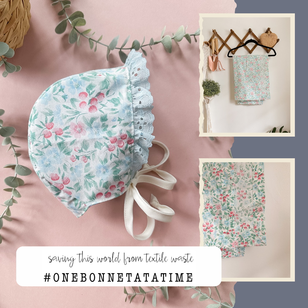 A floral bonnet with a ruffled brim and ribbon ties is displayed on a pink fabric background with eucalyptus leaves. Two smaller inset photos on the right show matching textile items hanging on a rack, and text at the bottom reads 'saving this world from textile waste #ONEBONNETATATIME'.