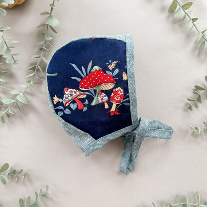 Navy bluebonnet with red mushroom design on a light background