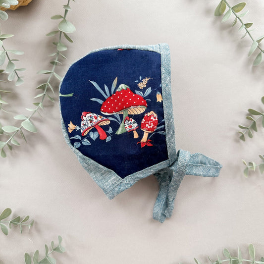 Navy bluebonnet with red mushroom design on a light background