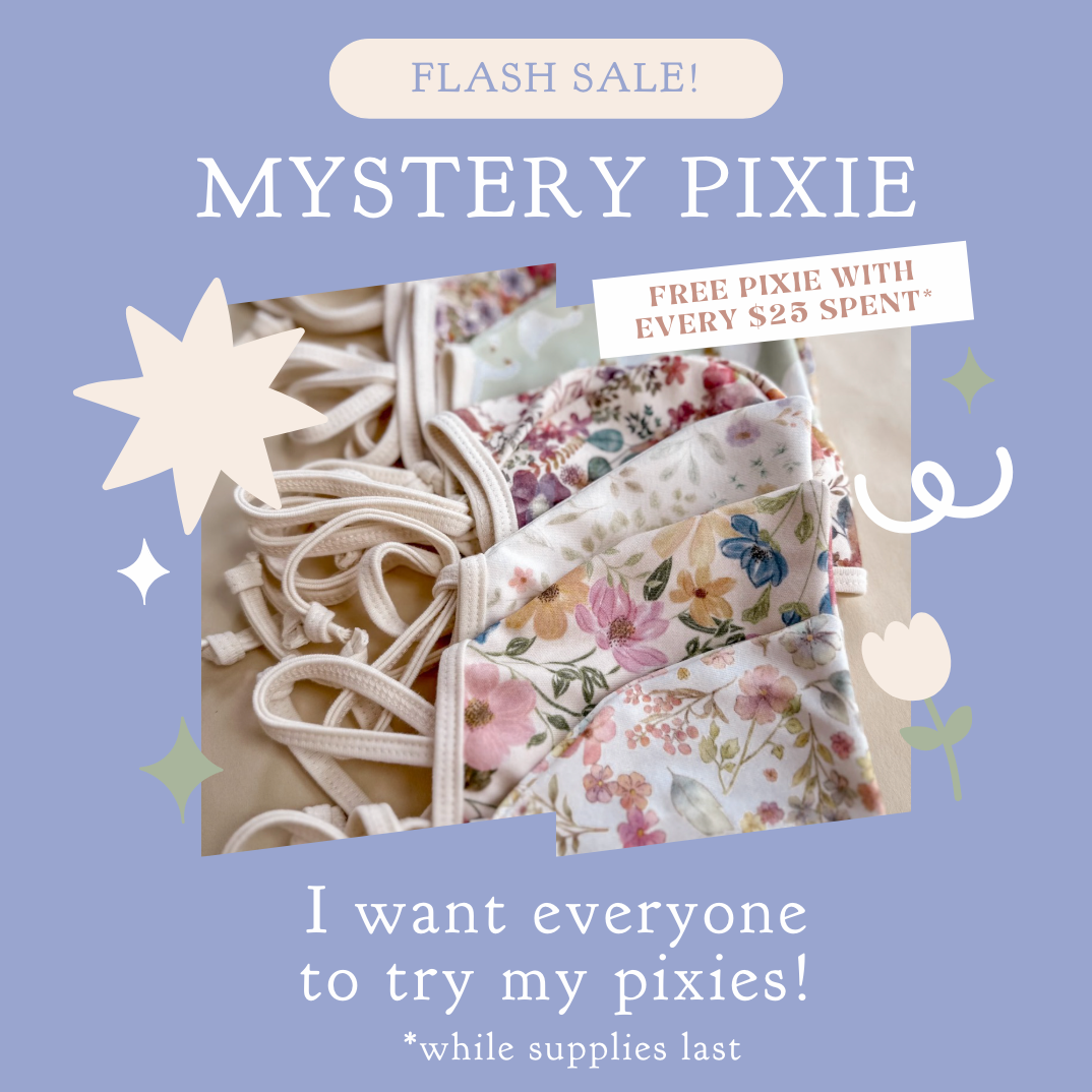 Promotional graphic for a 'Mystery Pixie' offering on a dusty lavender background. The design features a central tilted photo of various fabric face masks with floral prints and elastic straps, accompanied by decorative cream-colored doodles and text reading 'FLASH SALE!', 'MYSTERY PIXIE', and 'I want everyone to try my pixies! *while supplies last'.